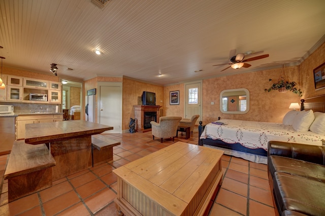 living room featuring light tile flooring and ceiling fan