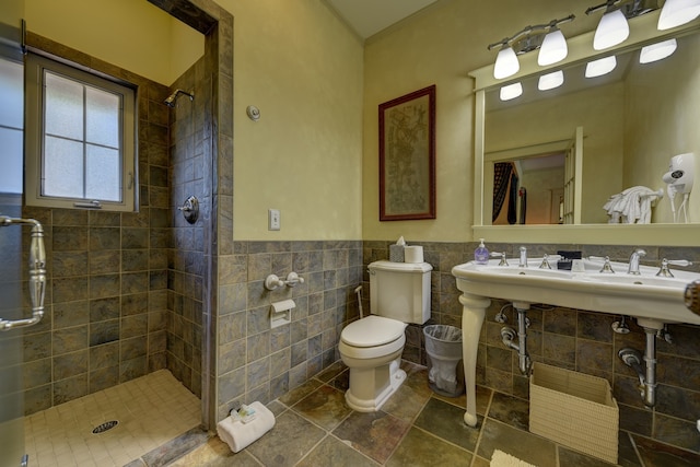 bathroom with toilet, tile walls, tiled shower, backsplash, and tile floors