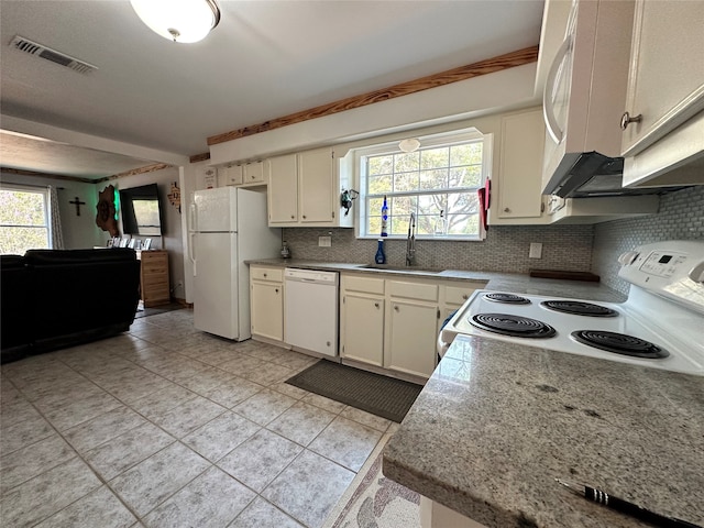 kitchen with backsplash, light tile floors, white appliances, and sink