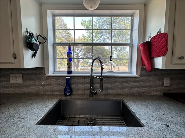 interior details featuring backsplash and sink