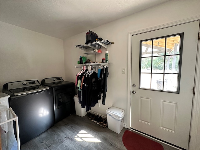 washroom with separate washer and dryer and dark wood-type flooring