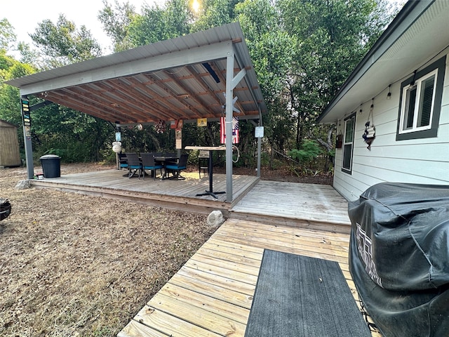 wooden terrace with a pergola and grilling area