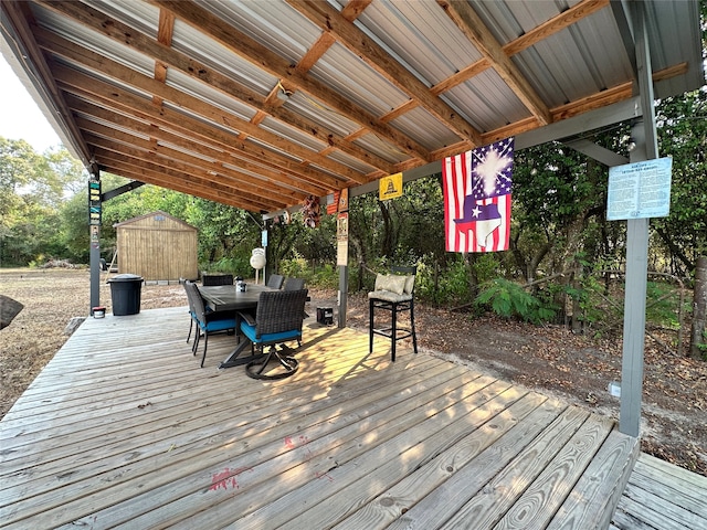 wooden terrace featuring a storage shed