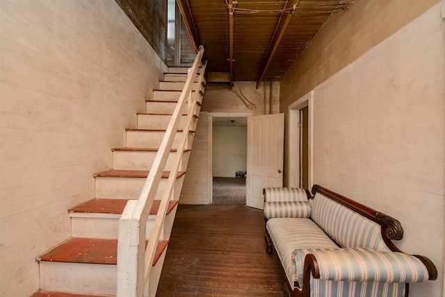 stairway featuring a towering ceiling