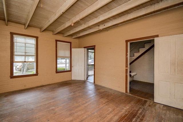 interior space with beamed ceiling, ensuite bathroom, wood-type flooring, and wooden ceiling