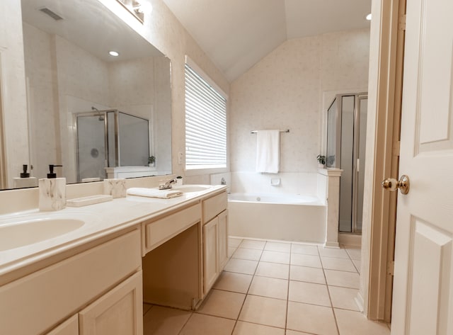 bathroom featuring independent shower and bath, vanity, lofted ceiling, and tile patterned floors