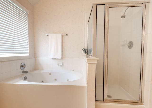 bathroom featuring shower with separate bathtub