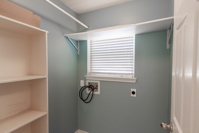 laundry room featuring hookup for an electric dryer, a textured ceiling, and hookup for a washing machine