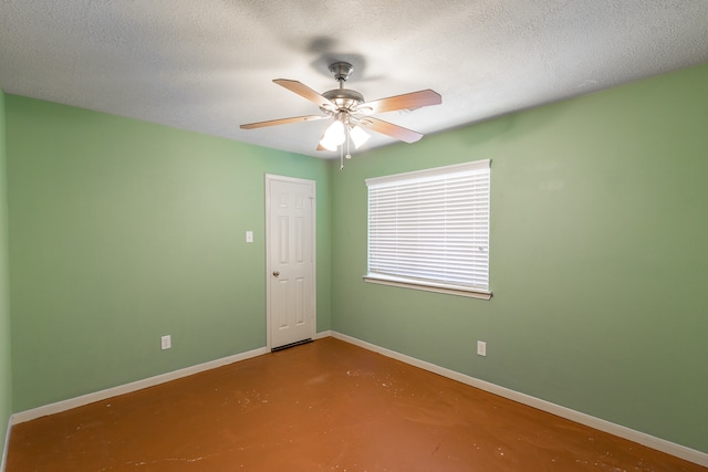 empty room with ceiling fan, a textured ceiling, and concrete flooring