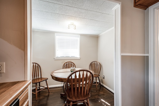 dining room featuring crown molding and dark hardwood / wood-style flooring