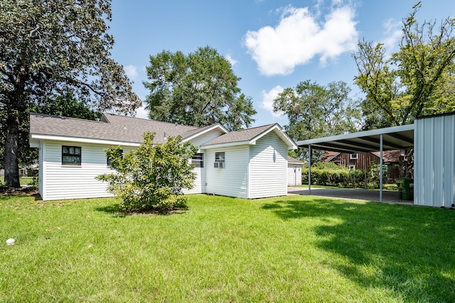 rear view of house featuring a yard and a shed