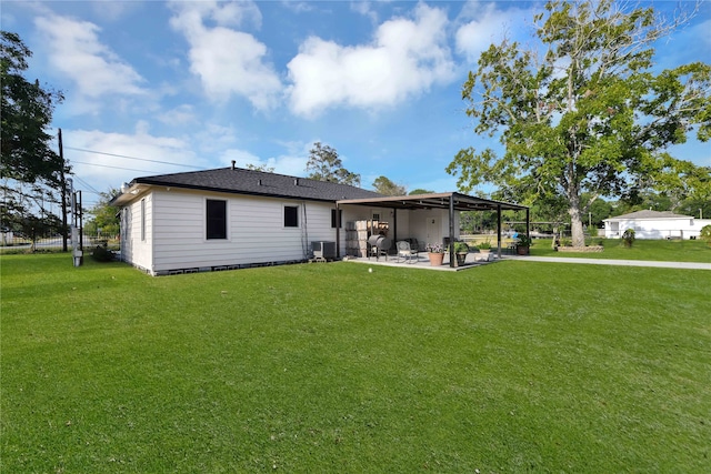 back of property with a patio, central AC unit, and a lawn