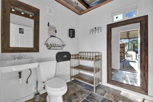 bathroom with sink, tile flooring, toilet, and plenty of natural light