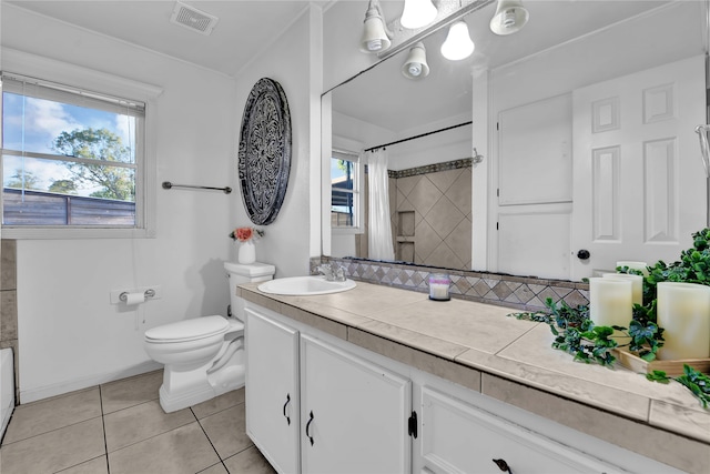 bathroom featuring tile flooring, toilet, and vanity with extensive cabinet space