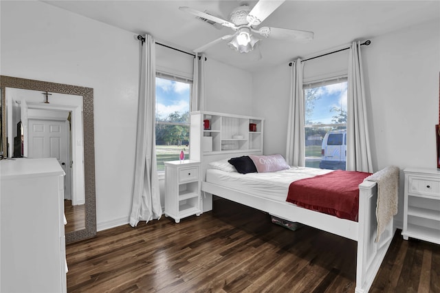 bedroom with ceiling fan and dark wood-type flooring