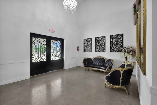 foyer featuring french doors and an inviting chandelier