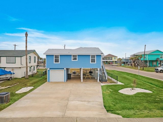 view of front of house with a front yard and a garage