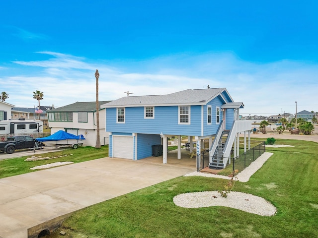 back of property with a lawn and a garage