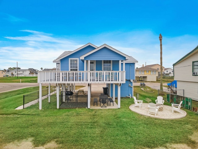 back of property featuring a lawn, a deck, and a patio area