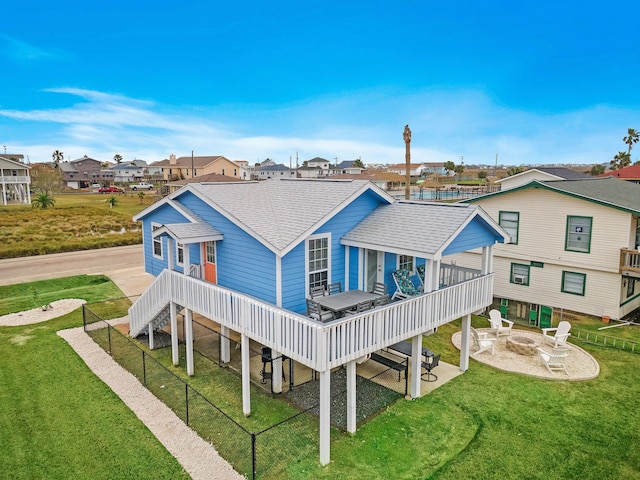 rear view of property featuring a wooden deck and a yard