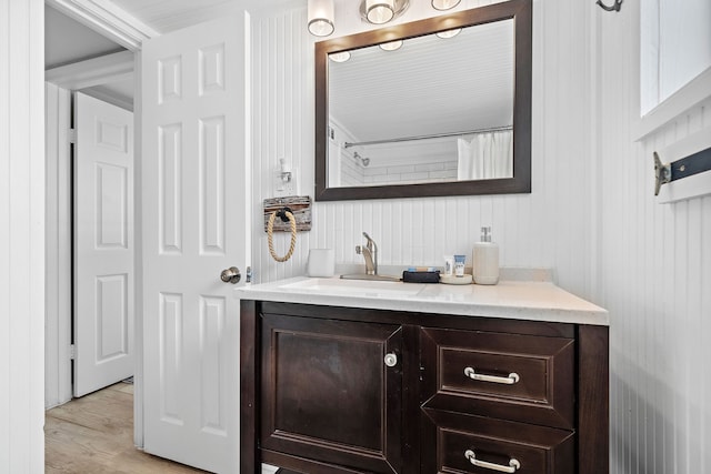 bathroom with oversized vanity and wood-type flooring