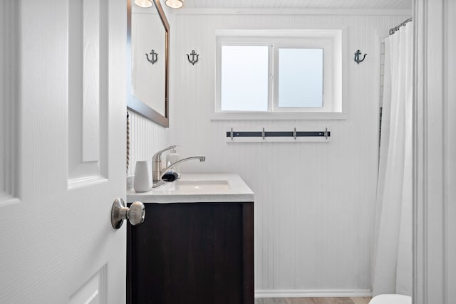 bathroom featuring toilet, wood-type flooring, and large vanity