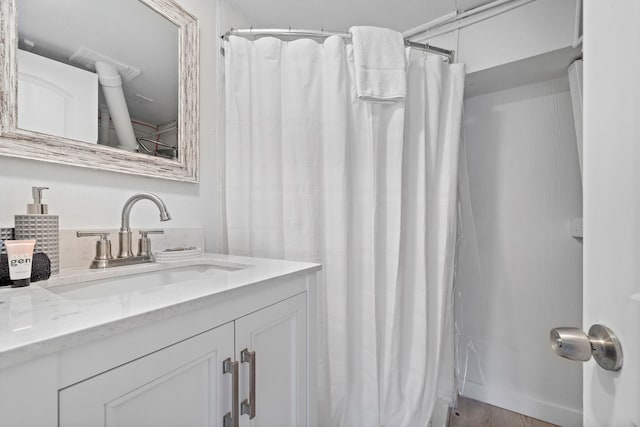 bathroom featuring large vanity and hardwood / wood-style flooring