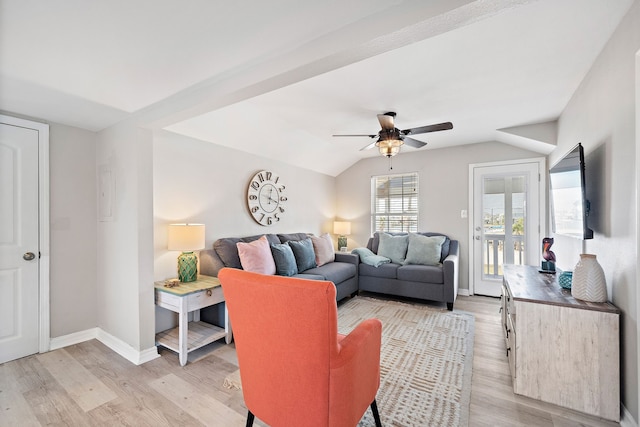 living room featuring ceiling fan, lofted ceiling, and light wood-type flooring