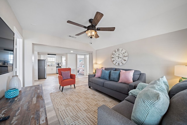 living room with light hardwood / wood-style floors and ceiling fan