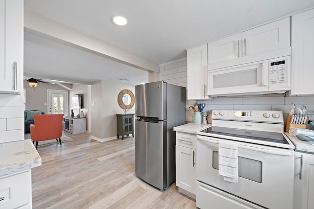 kitchen with light hardwood / wood-style floors, ceiling fan, white appliances, white cabinetry, and backsplash