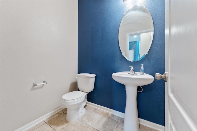 bathroom featuring tile patterned floors and toilet