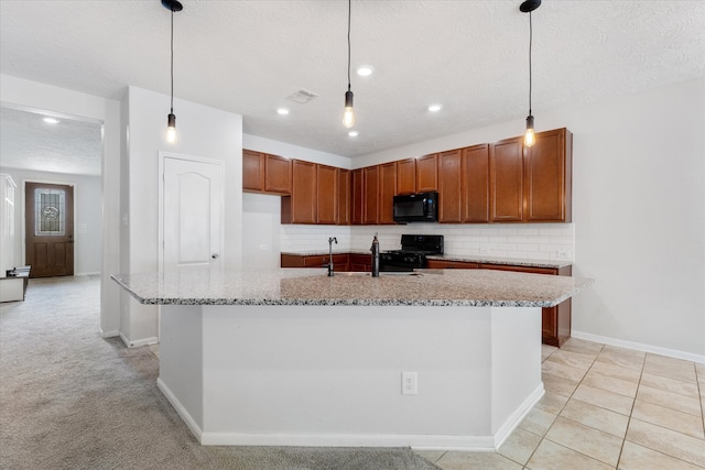 kitchen featuring light carpet, black appliances, an island with sink, a textured ceiling, and decorative light fixtures