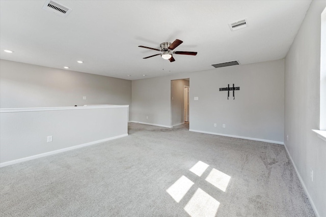 carpeted spare room featuring ceiling fan