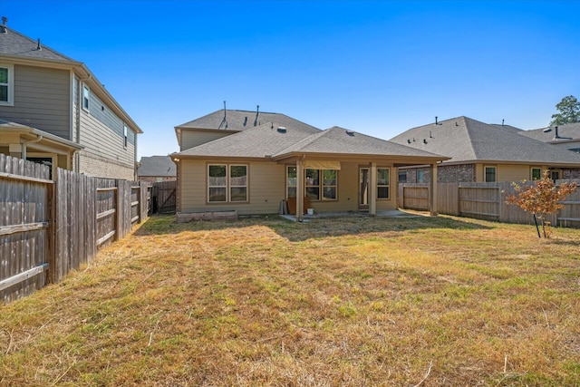 back of house featuring a yard