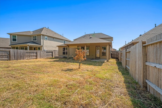 back of property featuring a lawn