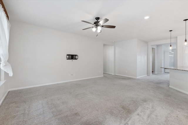 carpeted empty room featuring ceiling fan