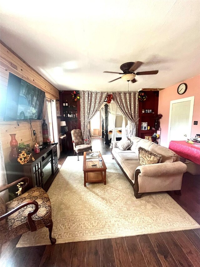 living room with wood-type flooring and ceiling fan