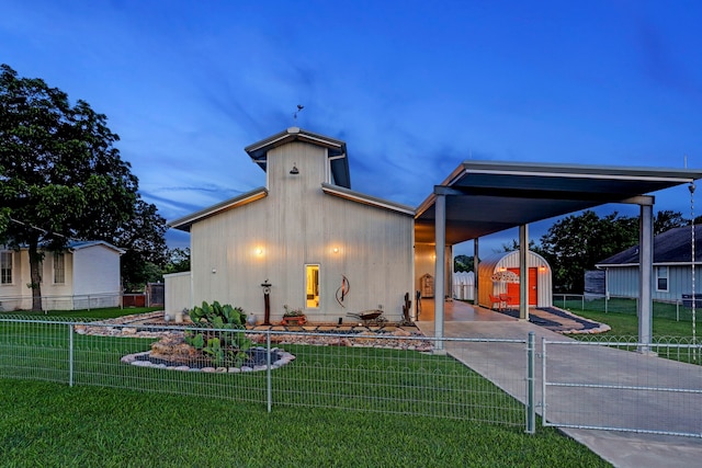 view of front of house with a lawn and a storage unit