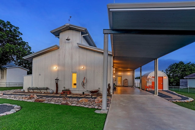 view of front of property with a patio, a storage shed, and a front lawn