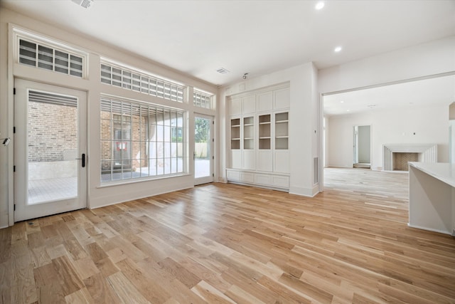 interior space with recessed lighting, visible vents, light wood finished floors, and baseboards