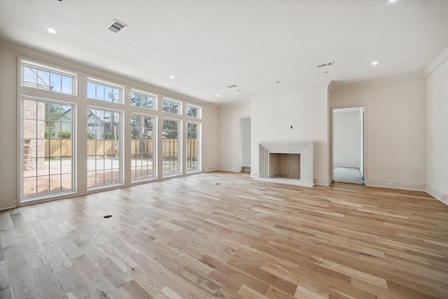 unfurnished living room with light hardwood / wood-style flooring and ornamental molding