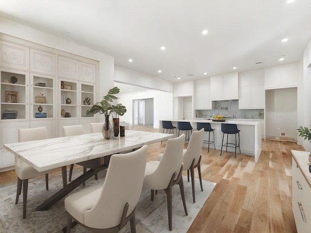 dining space featuring recessed lighting and light wood finished floors