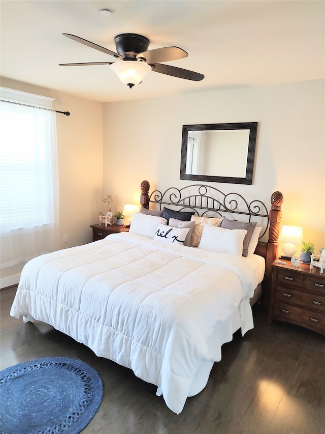 bedroom with ceiling fan and dark wood-type flooring