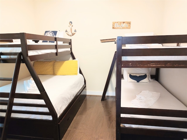 bedroom with dark wood-type flooring