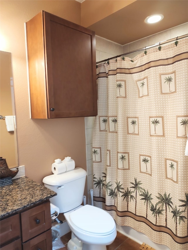 bathroom with vanity, tile floors, and toilet