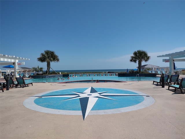 view of swimming pool with a water view