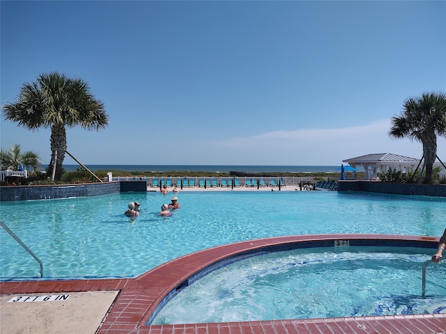 view of swimming pool with a community hot tub and a gazebo