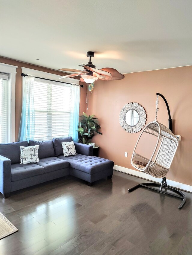 living room featuring a wealth of natural light, ceiling fan, and dark hardwood / wood-style flooring