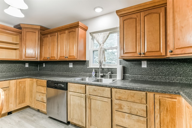 kitchen featuring sink, tasteful backsplash, light hardwood / wood-style flooring, and stainless steel dishwasher