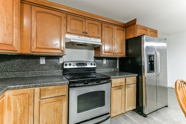 kitchen featuring light hardwood / wood-style floors, backsplash, and stainless steel appliances